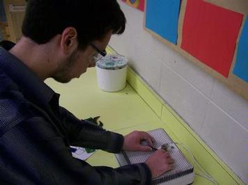 advanced student using glass grinder for stain glass